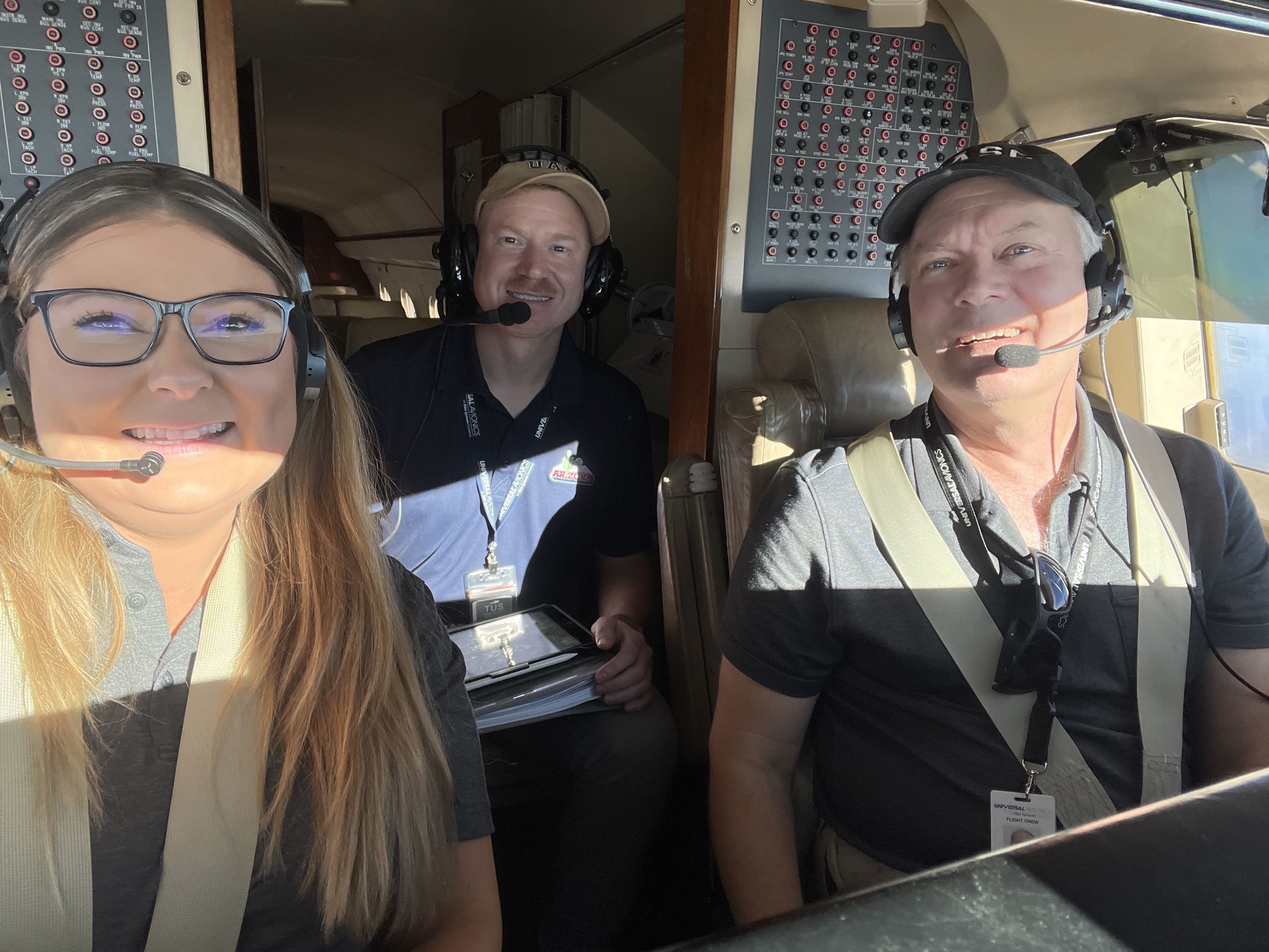 Sarah Tanis pictured amongst another mean inside of an airplane.