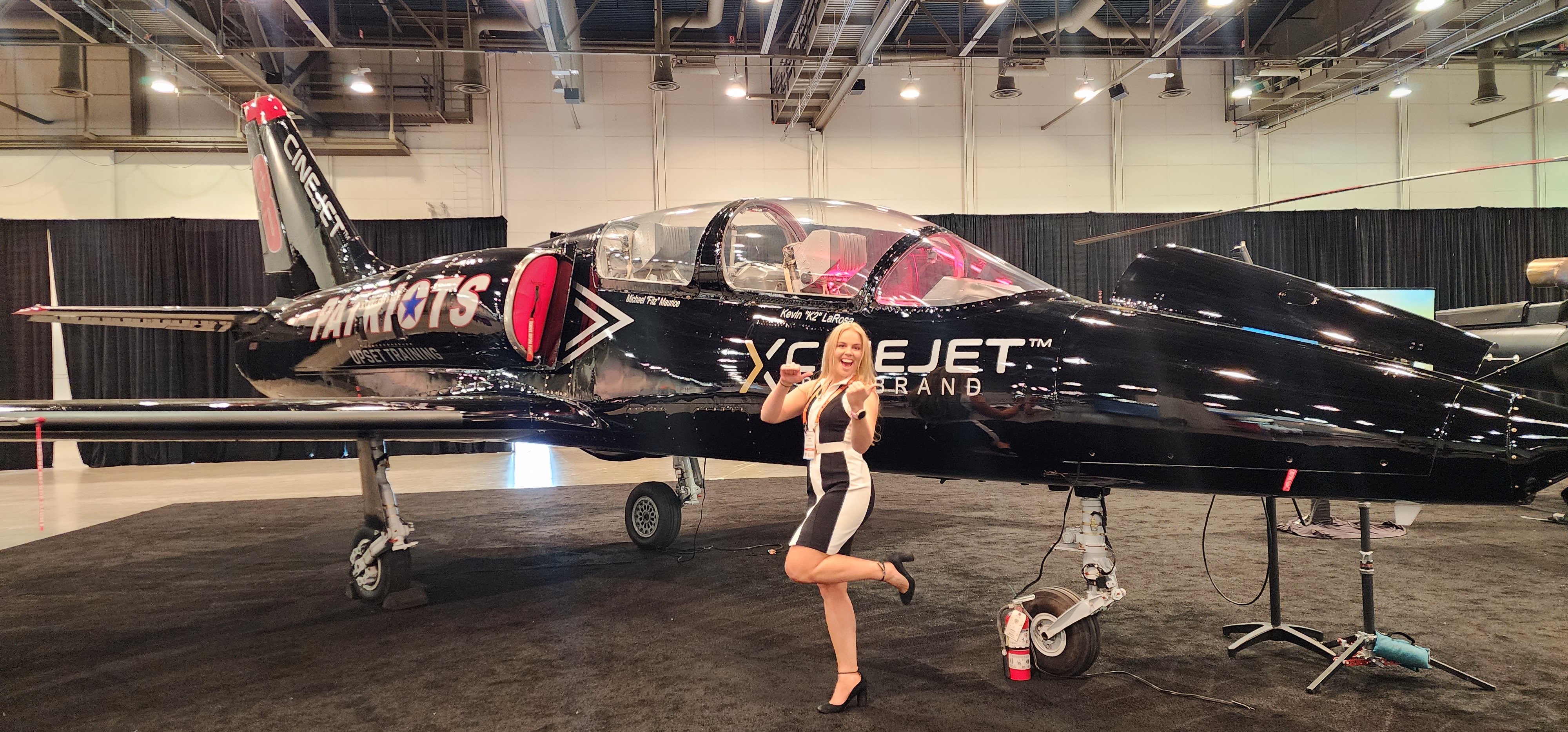 Anna standing in front of jet used to help film the movie 
