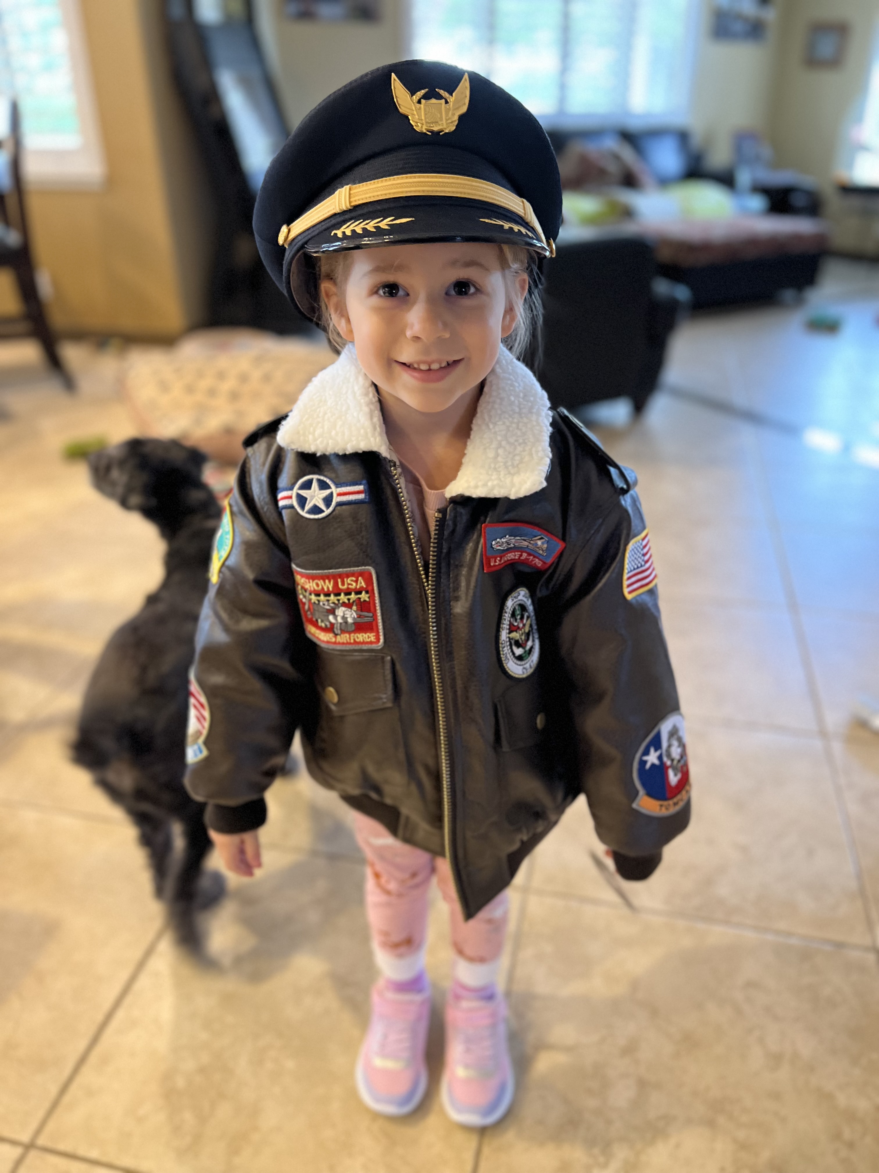 Sarah Tanis' daughter wearing her hat and bomber jacket.