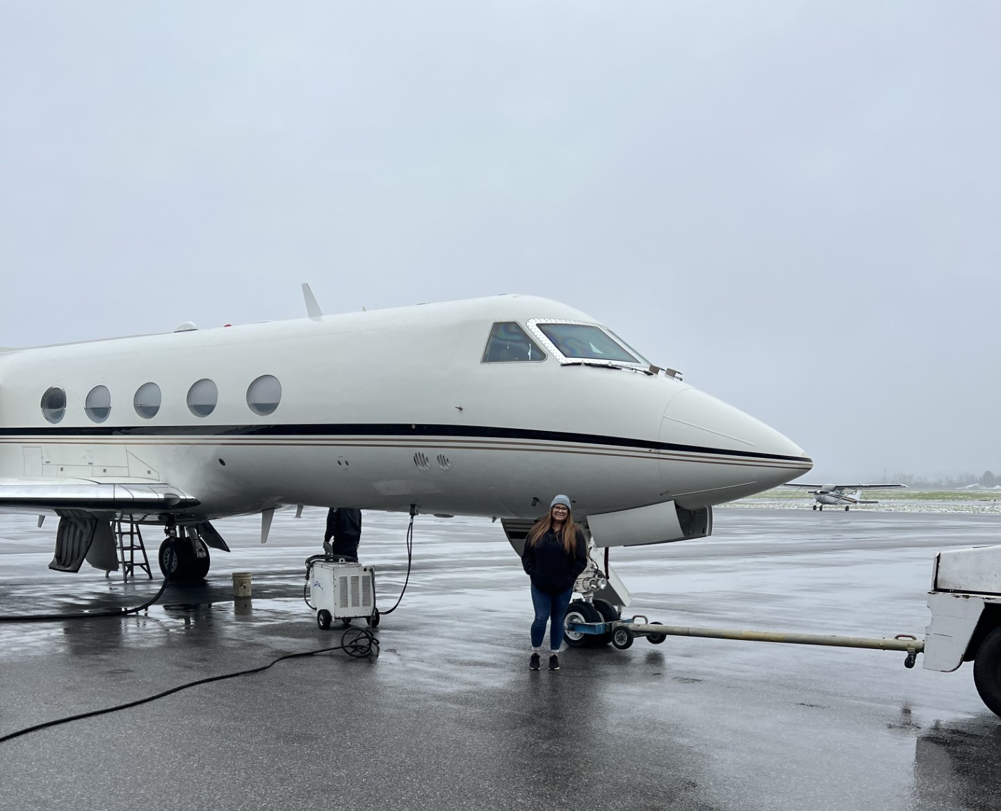 Sarah Tanis standing in front of Universal Avionics Gulfstream III
